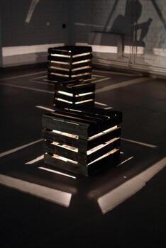 Illuminated Wooden Crates. A Captivating Display of Light and Shadow in a Modern Art Installation. photo