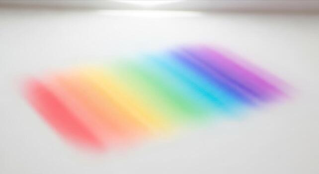 A prism projecting a vibrant rainbow spectrum of light onto a clean white background, showcasing the separation of colors and light refraction texture. photo