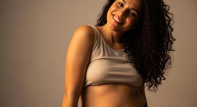 Smiling Woman with Curly Hair and Stretch Marks in Studio Portrait. photo