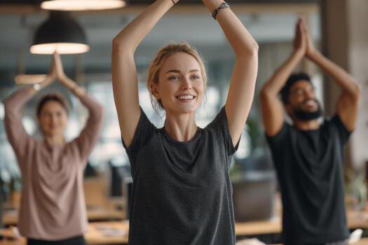 Three individuals engage in a yoga practice in a bright office environment. The group focuses on relaxation and mindfulness techniques to enhance well-being during working hours photo