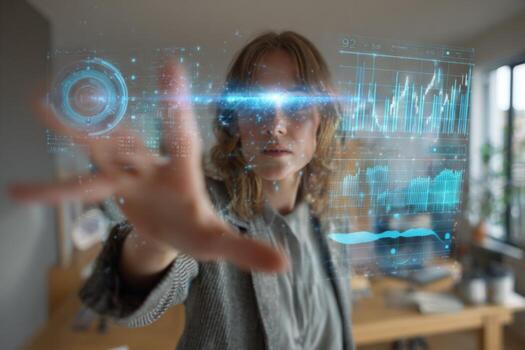 A woman engages with floating holographic data displays in a modern office. She uses her hand to manipulate graphs and information. Natural light illuminates the space photo