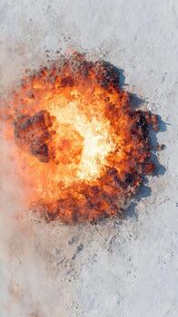 Explosion On Snowy Terrain Captured From Above. Dramatic Fiery Blast Contrasting With White Snow photo