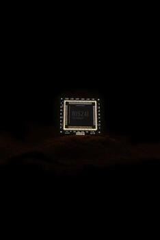 Illuminated RISZ41 processor core on a dark background, showcasing advanced technology and innovation photo