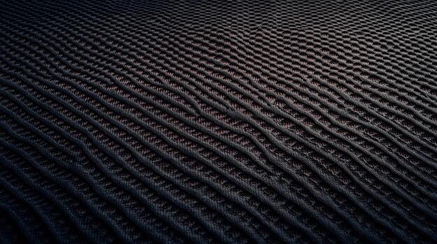 Textured surface with wavy patterns in dark colors under soft light photo