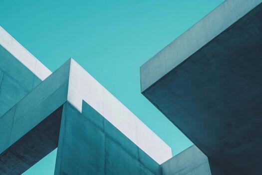 A striking view of angular concrete structures rises against a clear blue sky photo