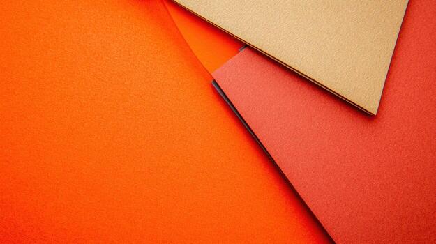 Colorful sheets of paper layered on a bright orange background photo