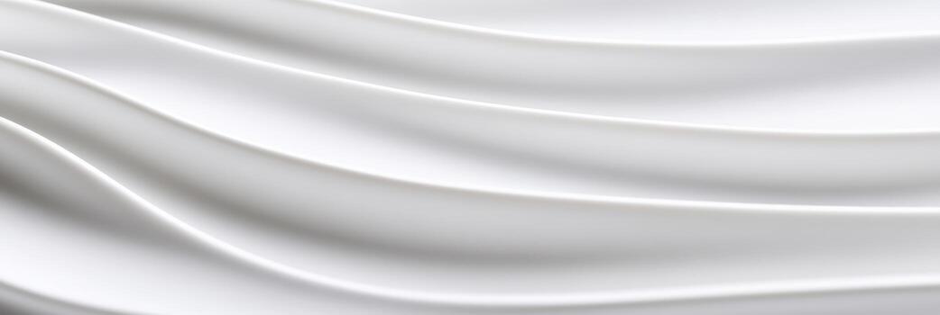 Smooth white fabric drapes in gentle waves creating a serene texture photo