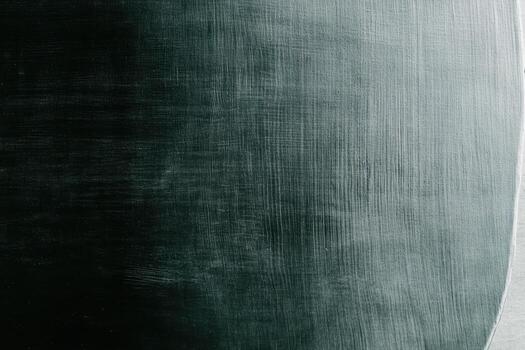 Texture of a dark surface captured in low light with smooth brush strokes photo