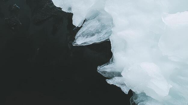Ice formations on dark water create a stark contrast in winter scene photo