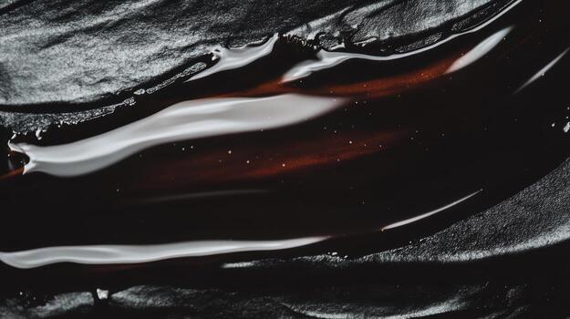 Liquid chocolate flowing over dark surface creates a rich visual contrast photo