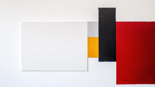 Modern abstract art on a white wall showcasing geometric shapes and colors photo