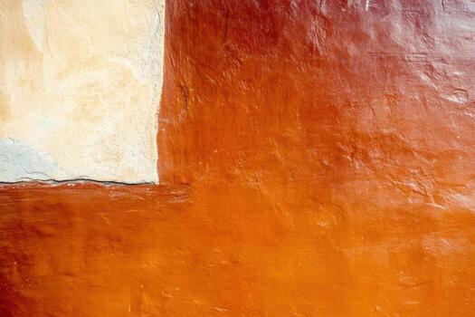 Textured wall with vibrant orange and beige paint in a rustic setting photo