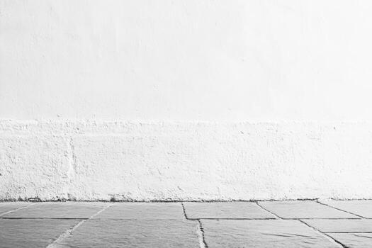 Simple background of a textured wall and stone floor in muted tones photo