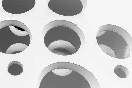Unique white wall design with circular cutouts and reflections photo
