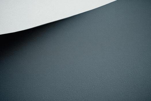 Dark textured surface with a light paper edge creating contrast in design photo