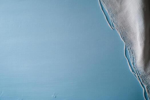 Blue textured surface with a white fabric edge creating a minimal design photo