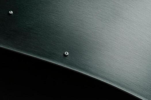 Close-up of polished metal surface with rivets and sleek texture photo