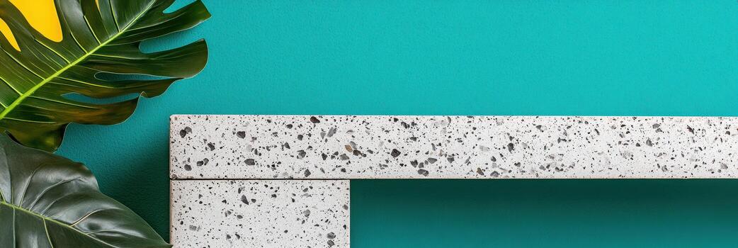 Bright teal background with terrazzo shelf and tropical leaves in modern space photo