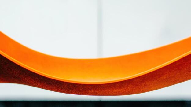 Bright orange curves on a minimalistic background create bold visual interest photo