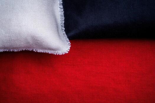 Colorful textile arrangement features red, black, and gray fabrics on display photo