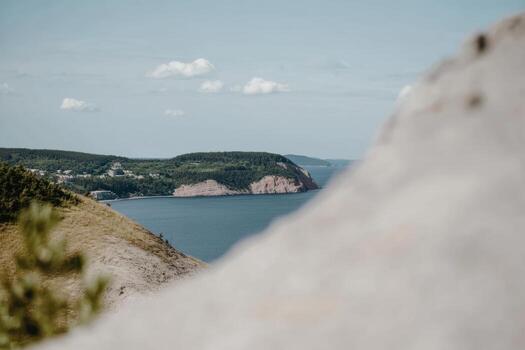 Scenic view of coastline and hills on a sunny day in the background photo