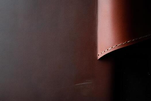 Leather craftsmanship showcasing fine stitching and texture in workshop photo