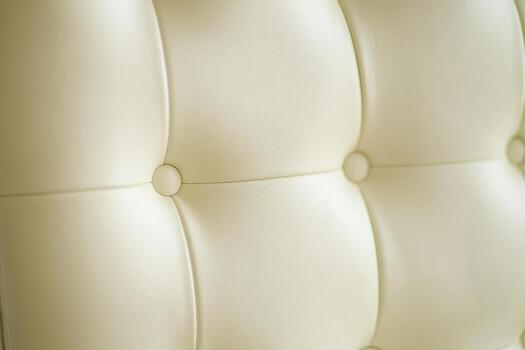 Close up view of a soft cream-colored upholstered chair fabric photo