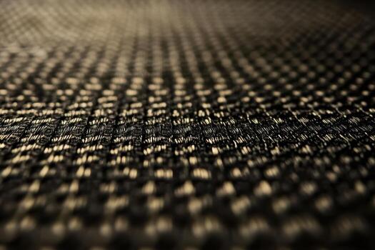 Close-up view of woven texture showcasing black and gold patterns photo