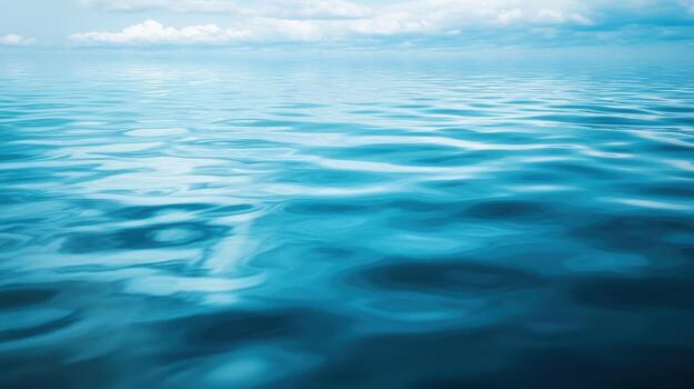 Calm blue ocean waves reflect clouds in a serene atmosphere photo