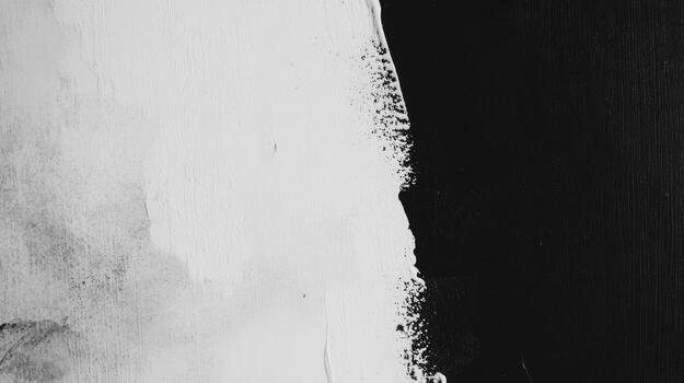 Artistic contrast of black and white paint merging on a textured surface photo