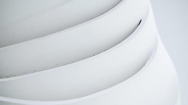 Curved white surfaces create a striking geometric pattern in clean design photo