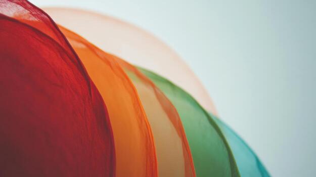 Colorful layers of translucent fabric arranged artistically in soft light photo