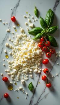 Fresh basil, tomatoes and cheese on a marble surface photo