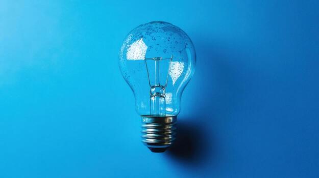 A light bulb on a blue background photo