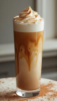 A coffee drink with whipped cream and cinnamon photo