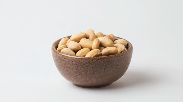 A brown bowl filled with peanuts on a white background photo