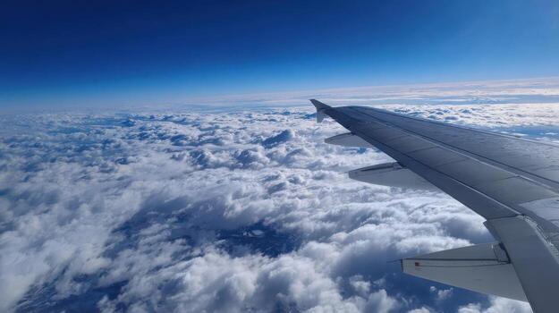 A View From Above The Clouds Through An Airplanes Window photo