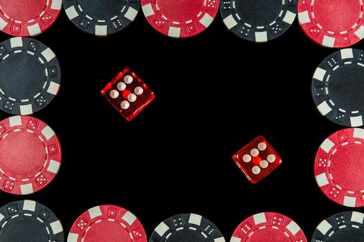 Red dice with a maximum winning combination of twelve in Craps on black table and chips photo