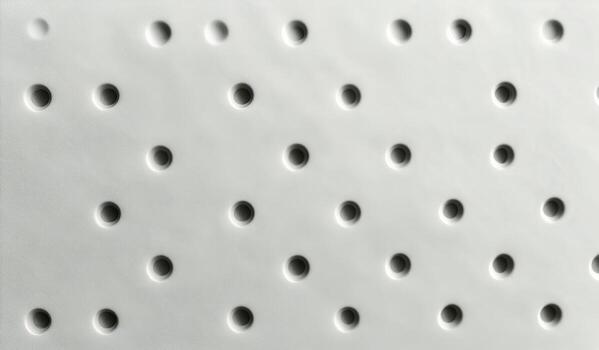 White Surface With Regularly Spaced Round Holes Casting Shadows at Daytime photo