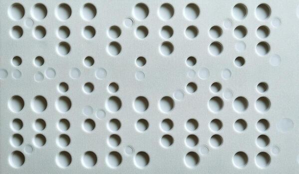 Surface With Many Circular Indentations Creating Interesting Patterns and Subtle Shadows. photo