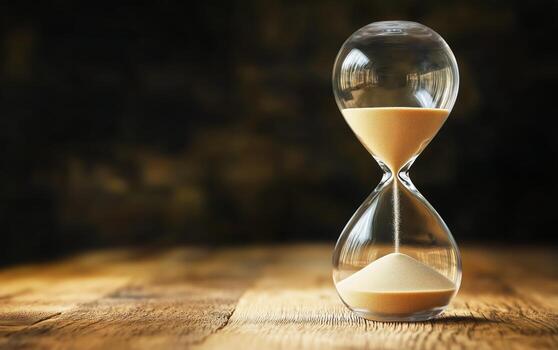 Hourglass on a Wooden Table Captures the Essence of Time Passing in a Serene Setting photo