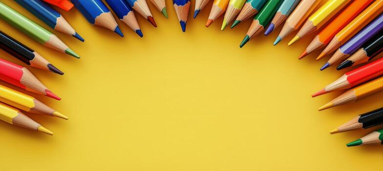 Colorful Pencils Arranged in a Neat Row on a Bright Yellow Background Showcasing Art Supplies. photo