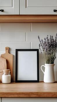 Modern Kitchen Display With Empty Frame, Cutting Board, and Fresh Lavender in White Pitcher photo