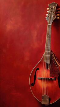 Beautiful Mandolin Resting Against a Textured Red Background Showcasing Its Elegant Curves and Craftsmanship. photo
