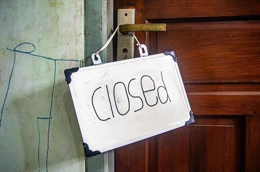 Handwritten closed sign hanging on brass door handle, symbolizing pause, rest, and personal boundaries in a quiet, mindful space photo