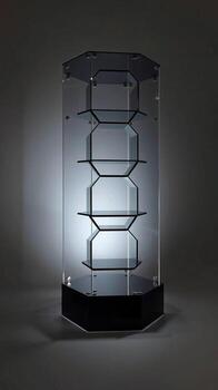 Modern octagonal display case with multiple glass shelves illuminated by spotlight photo