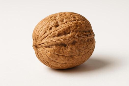 A walnut in a shell on a light background creates an attractive and natural image, emphasizing its texture and nutritional properties, ideal for culinary and healthy recipes. photo