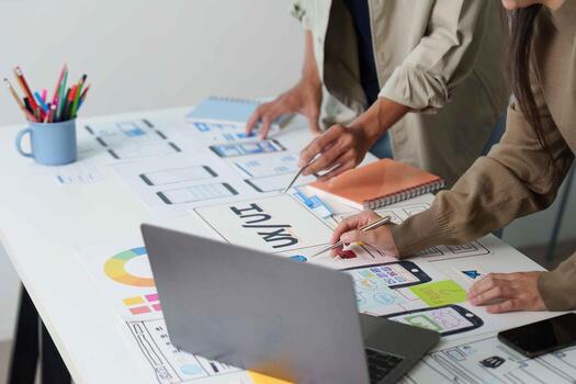 Designers Collaborating on UX UI Concepts in Bright Workspace photo