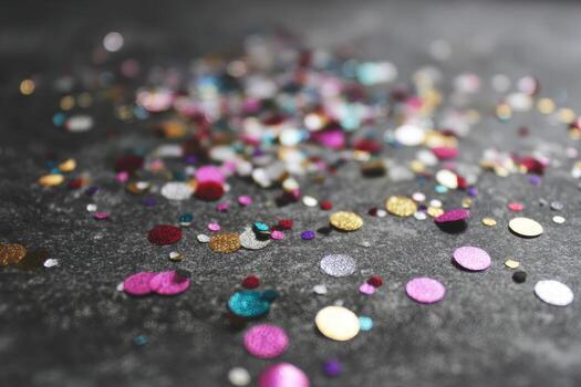 Festive confetti scattered on dark surface photo