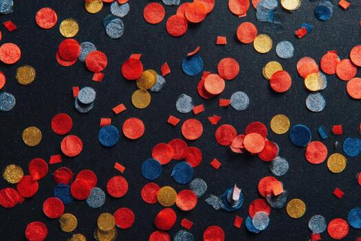 Colorful confetti scattered on dark background photo